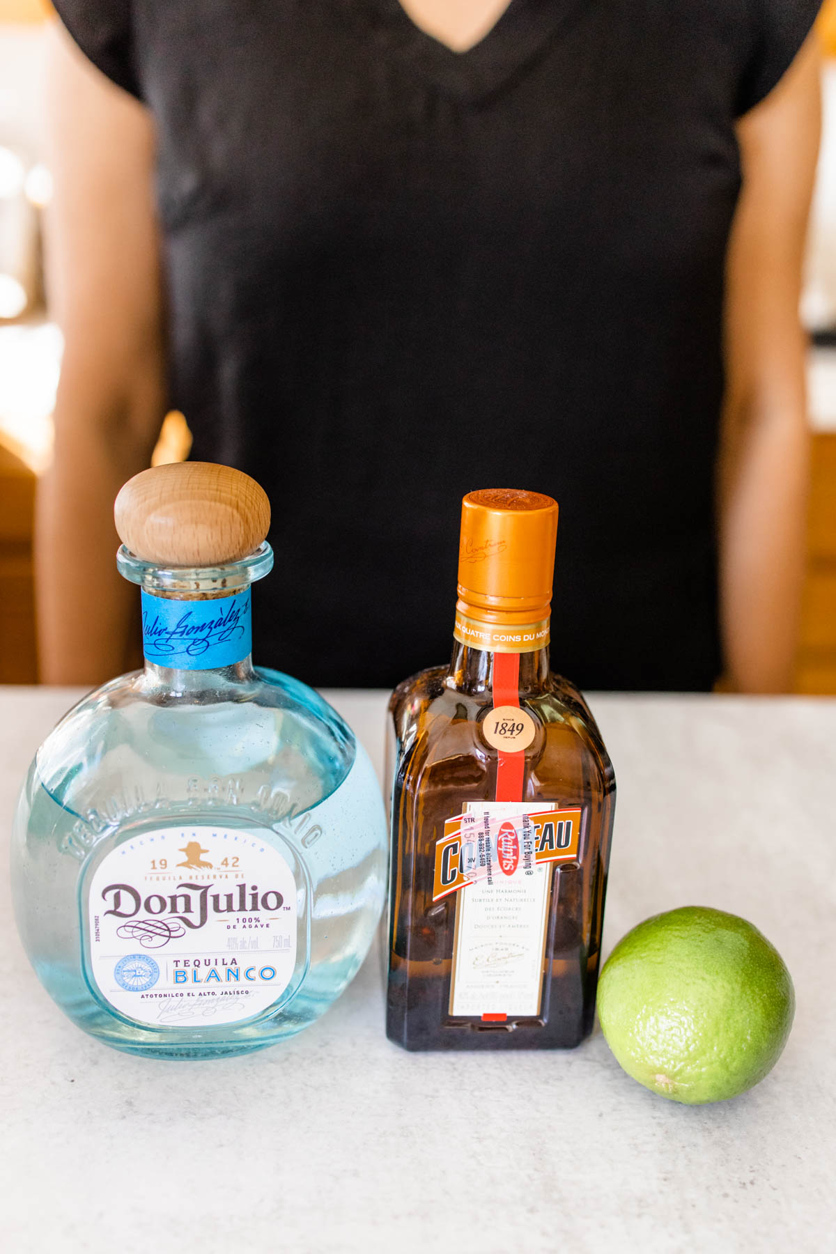 Ingredients to make a classic 3 ingredient margarita recipe on a counter.