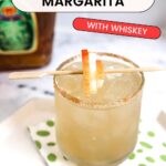 Text: Crown Apple Margarita with Whiskey with a short cocktail glass with a spiced sugar rim on a napkin with an apple garnish.