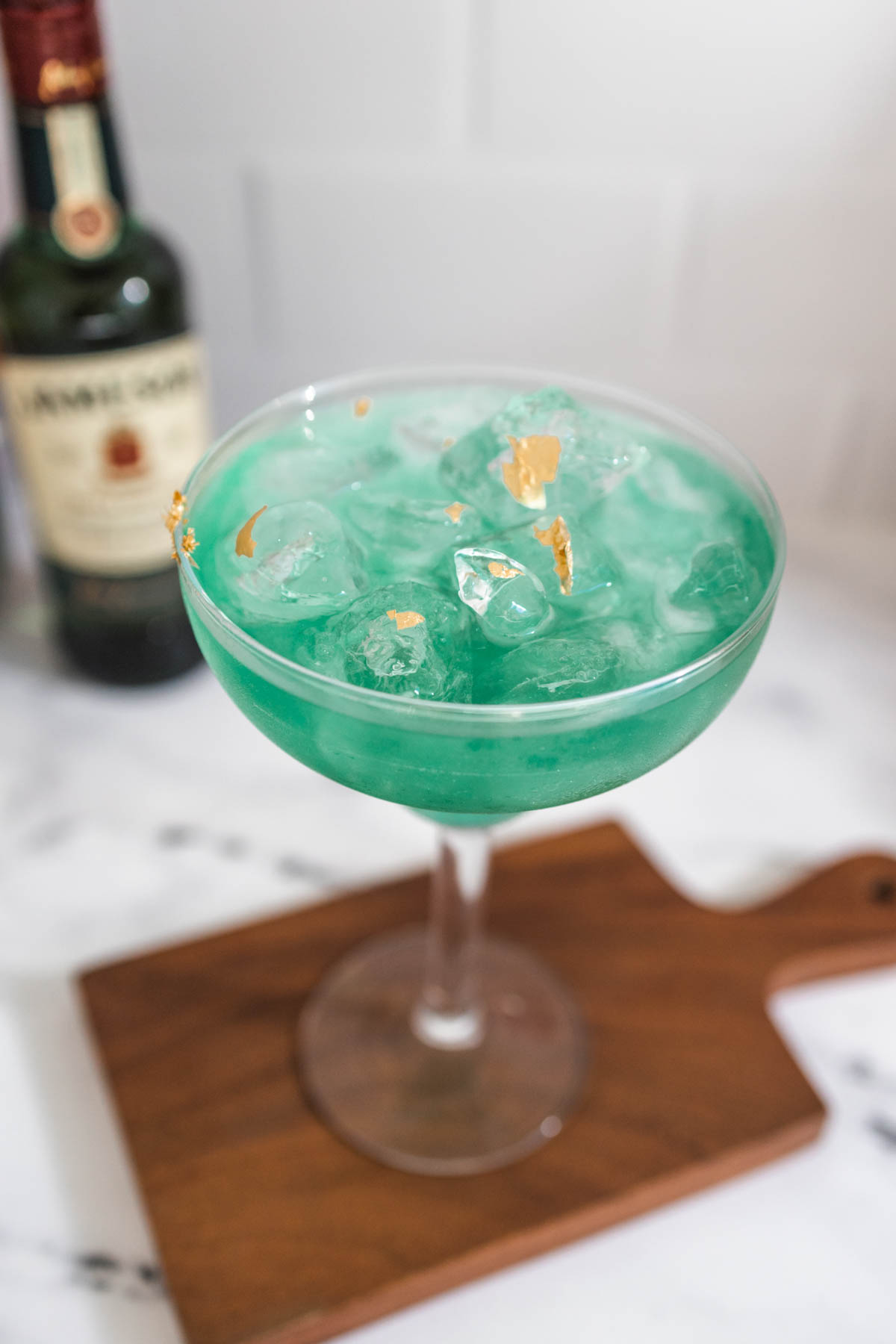 An Irish Margarita for St. Patrick's Day with green glitter and edible gold leaf.