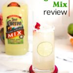 Jose Cuervo Margarita Mix Review with a glass on a table next to a bottle of Jose Cuervo margarita mix.