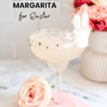 Text: Strawberry Lemonade Margarita for Easter with a light pink margarita in a margarita glass with a mashmallow garnish that looks like a bunny.