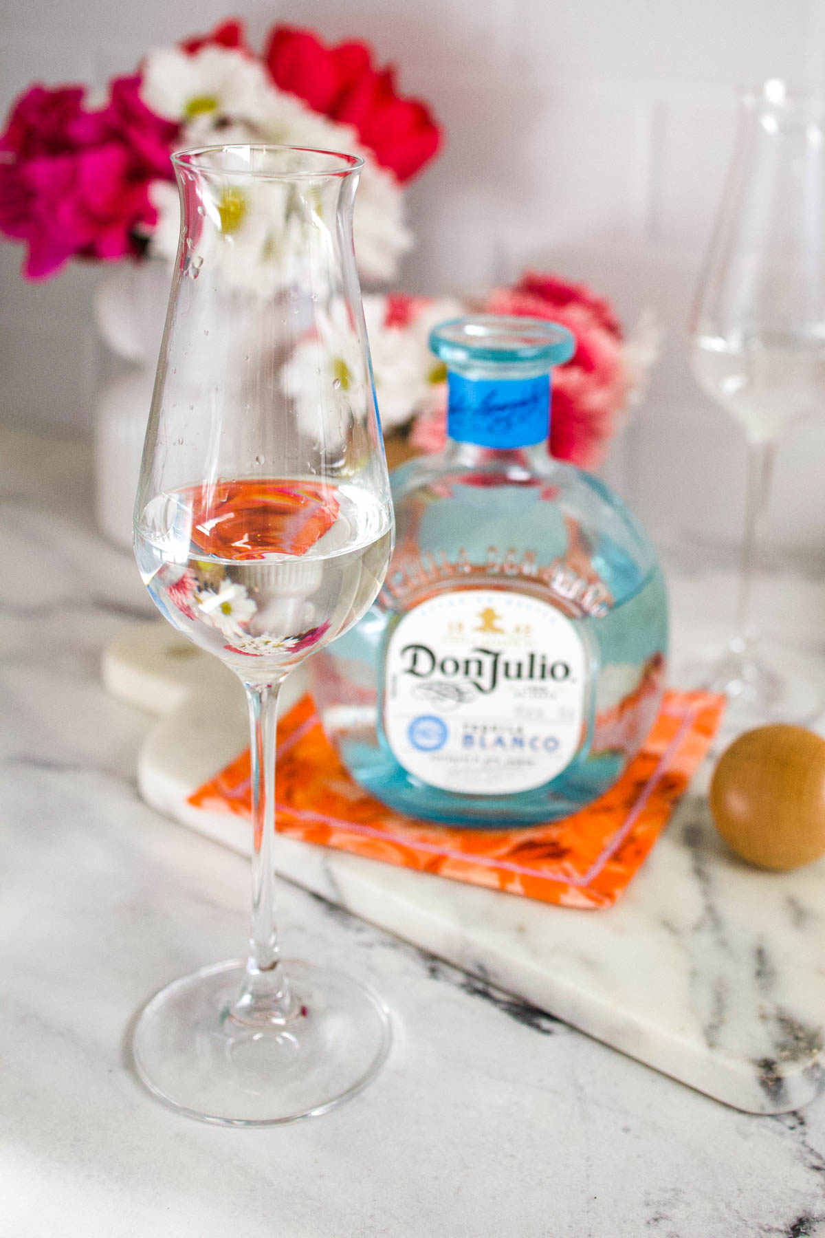 Two pieces of crystal clear tequila flutes and a Don Julio Tequila Blanco.