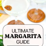 Clear margaritas with salted rim and dried lime as garnish.