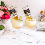 Two frozen beer margaritas with an inverted bottle of Corona Light Beer in each.