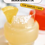 A closeup shot of a yellow Wolverine margarita in a salt-rimmed glass with the text "Wolverine Margarita" on top.