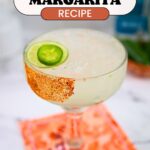 Text: Simple Spicy Margarita Recipe with a margarita glass with a partial Tajin rim and a slice of jalapeno.